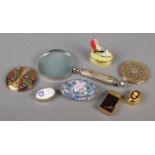 A Mackintosh style magnifying glass, along with a collection of pill boxes, compacts, musical