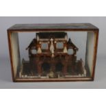 A glass cased church diorama constructed with cork stoppers. Case is missing back panel.