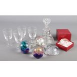 A collection of glass. Includes Caithness paperweights, drinking glasses and a cut glass bell.