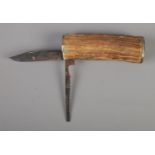 A large horn bodied multi bladed knife, with one serrated blade. Stamped G-W-P to one end. CAN NOT
