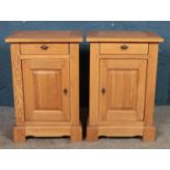 A pair of modern oak bedside cabinets, with draw and cupboard doors. Height: 77cm, Width: 52cm,