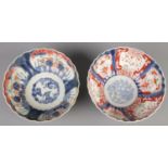 Two Japanese Imari bowls. Both 24cm diameter. Hairline crack to one bowl.