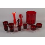 A collection of red glassware including vases, glasses, etc.