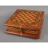 A carved miniature chess board with singular storage drawer. Approx. dimensions 31cm x 31cm x 11.
