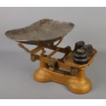 A set of vintage cast iron scales with some weights.