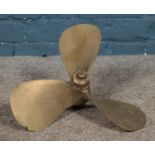 A brass three blade propellor stamped COBI.