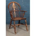 An ash/elm Windsor armchair. Repair to back.