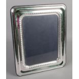 A large silver mounted photo frame. (33cm x 27cm) Hallmarks faded.