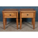 A pair of hardwood bedside tables with single drawers.
