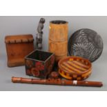 A quantity of woodenware. Includes bamboo planter, pipe stand, African carved figure, bowl, etc.
