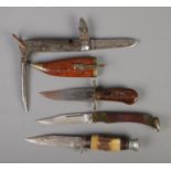 Four knives. Includes large John Mcclory folding knife, Eastern dagger, small hunting knife and
