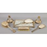 A collection of dressing table items, to include raised stand, hand mirrors and brushes.