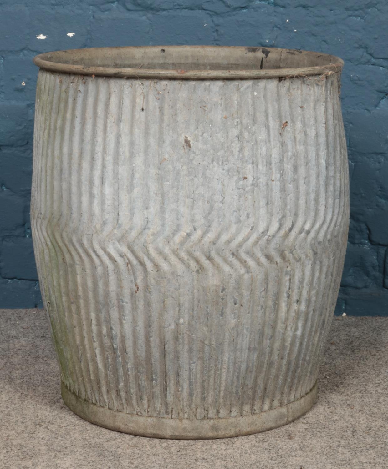 A galvanised metal dolly tub. 53cm high. Holes to the bottom; has been used as a planter.