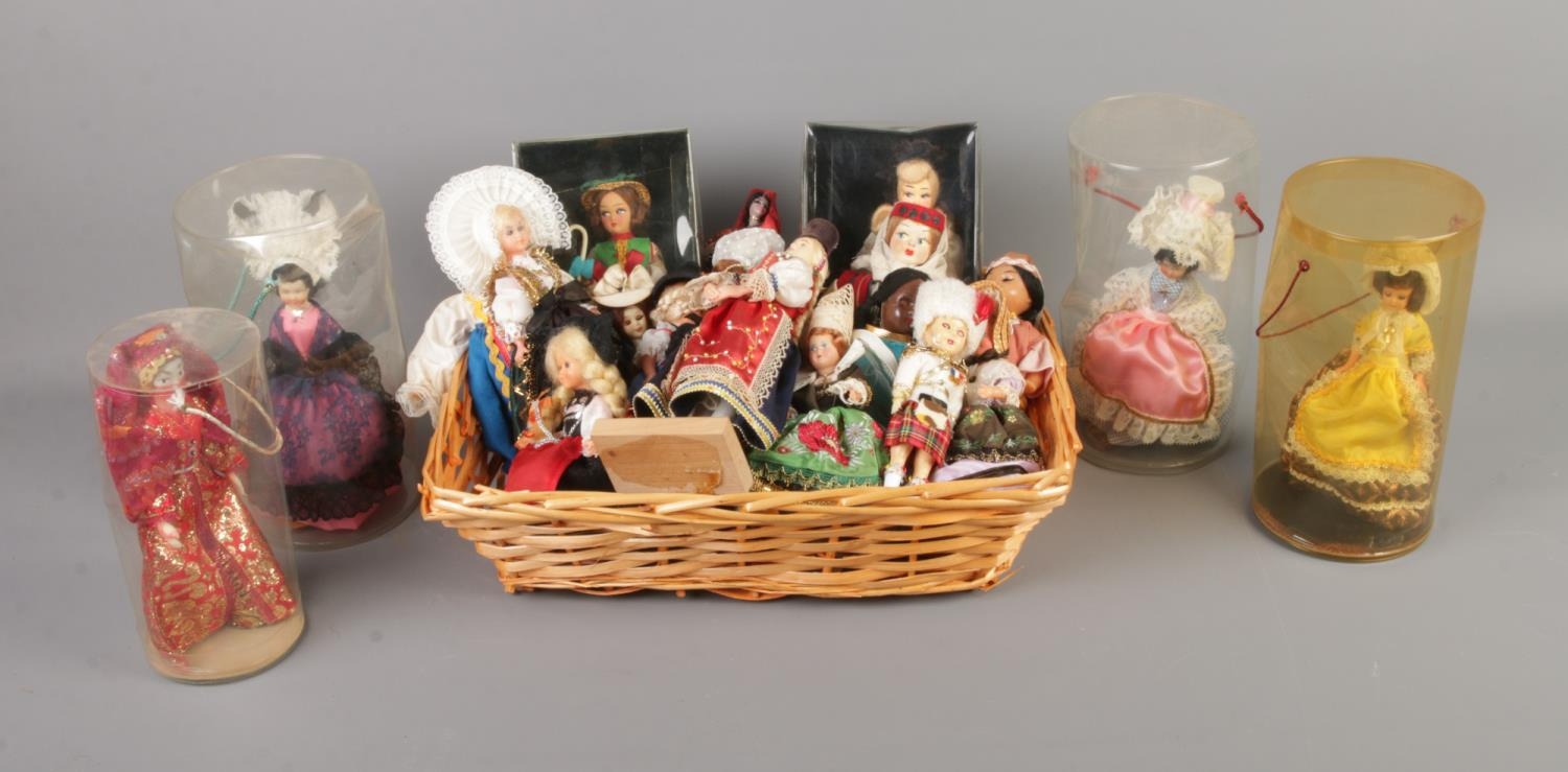 A collection of small international doll figures including several boxed examples.