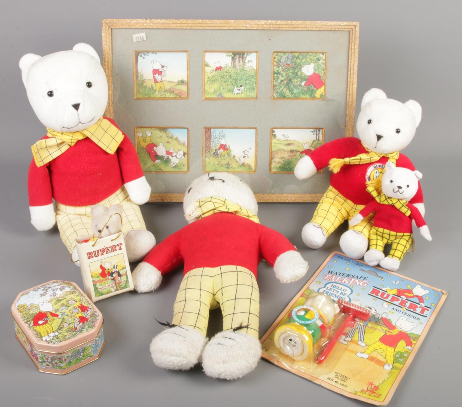 A quantity of Rupert Bear collectables. Includes teddy bears, boxed toy, tin, print, etc.