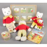A quantity of Rupert Bear collectables. Includes teddy bears, boxed toy, tin, print, etc.