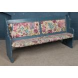 A painted pine pew with floral upholstered seat and pack. Length: 166cm, Height: 86cm.