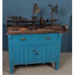 A painted workbench. Comprising of lathe, Herbert Terry task lamp, pillar drill, etc.