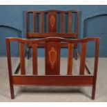 An Edwardian mahogany double bed frame, with inlay decoration to headboard and footboard. Height: