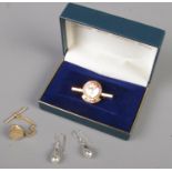 A small quantity of jewellery. Includes 9ct gold tie pin, pair of silver earrings and a silver
