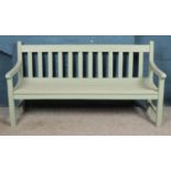 A large painted wooden garden bench, with slatted back and base. Height: 98cm, Length: 182cm, Depth: