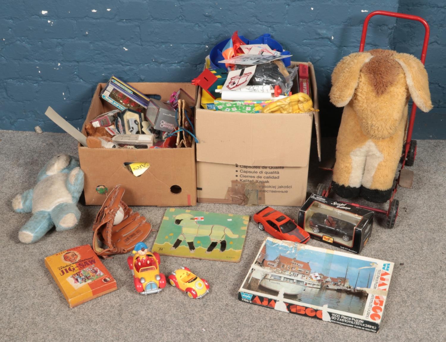 Two boxes of toys and games. Includes diecast, push along horse, baseball glove & ball, jigsaws,