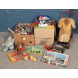 Two boxes of toys and games. Includes diecast, push along horse, baseball glove & ball, jigsaws,