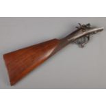 A W.H. Monks decommissioned double barrel shotgun walnut stock. All pieces function.