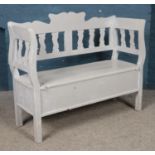 A painted pine monks bench, with lift up storage seat. Height: 95cm, Width: 121cm, Depth: 44cm.