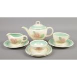 A Susie Cooper part tea set by Crown Works Burslem. Decorated with roses.