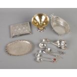 A collection of continental silver items including spoons, serving basket, tray, etc. Also