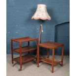 A three tier tea trolley, along with similar table and standard lamp.