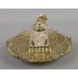 A decorative oriental style brass inkwell featuring insect top.