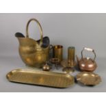 A collection of brass and copper items. Includes coal scuttle, kettle, artillery shells, crocodile