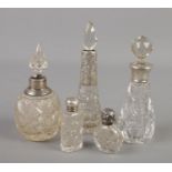 Five silver mounted cut glass scent bottles.