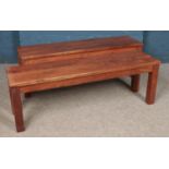 Two modern hardwood benches. Length: 138cm.