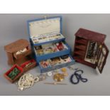 Three jewellery boxes with contents of costume jewellery. Includes brooches, beads, necklaces,