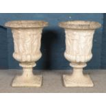 A large pair of cast concrete Medici style garden urns, with classical decoration, on fluted socle