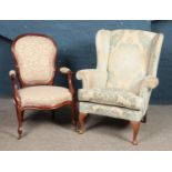 A wingback armchair with floral upholstery and cabriole feet, together with a mahogany spoon back