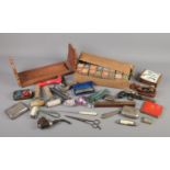 A box of collectables. Includes pipe, folding knives, ink rollers, book trough, German tinplate