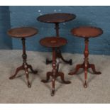 A collection of four wine tables. One with loose top.