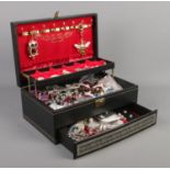 A cantilever jewellery box, with contents of costume jewellery. To include necklaces, earrings and