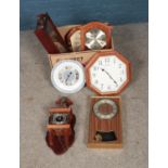 A box of quartz wall clocks including Seiko, Abbey and Atlas examples.