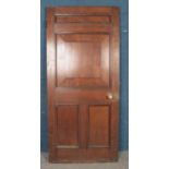 A large panelled oak door, with brass handle and key. Height: 204cm, Width: 90cm.