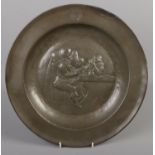 A pewter charger decorated with tavern scene. Touch mark to the top. (35cm diameter)