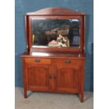 A mahogany bevel edged mirror back sideboard, with arched top and two drawers over cupboard base.