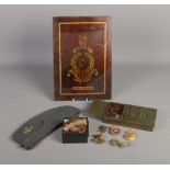 A collection of military collectables including RAF Officers side cap, cap badges, patches, etc.