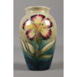 A Moorcroft orchid vase with blue green glaze. Height 10.5cm. Good condition.