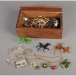 A wooden box containing an assortment of costume jewellery along with small quantity of art glass