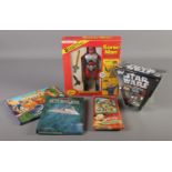 A box of toys and books. Includes Topps Star Wars Candy Containers with cards, boxed Sonic Man,